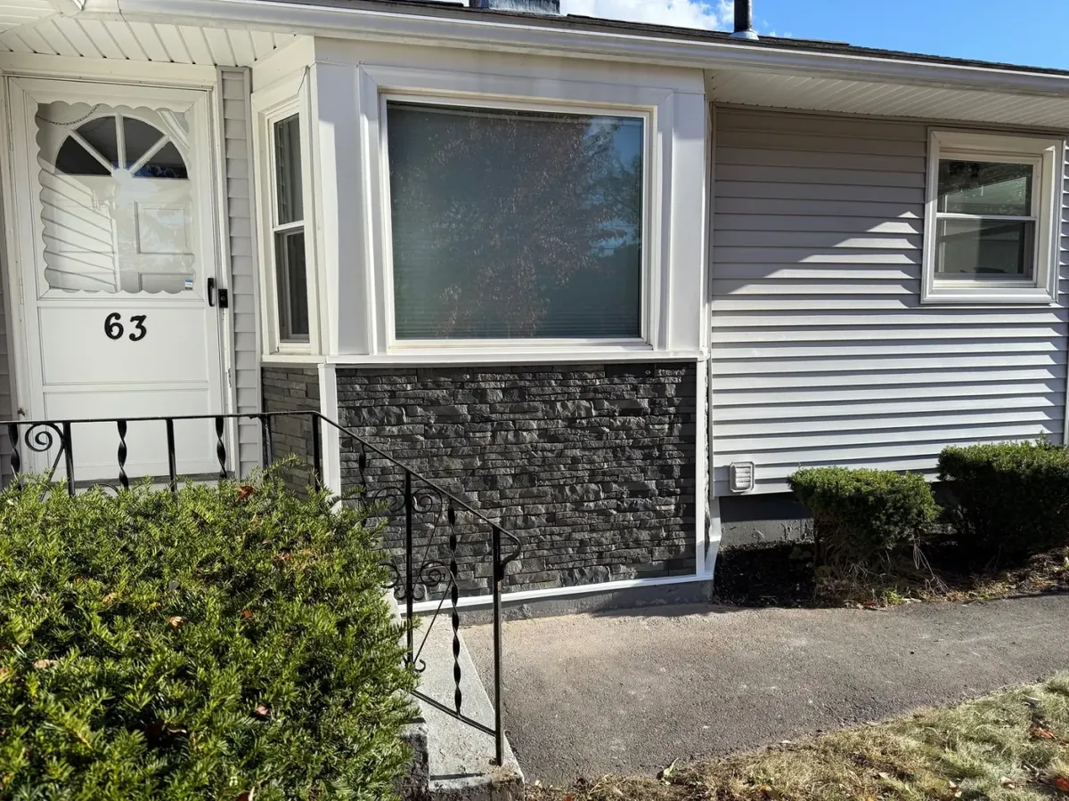 Window and door installation with stone facade by Westfield Builders